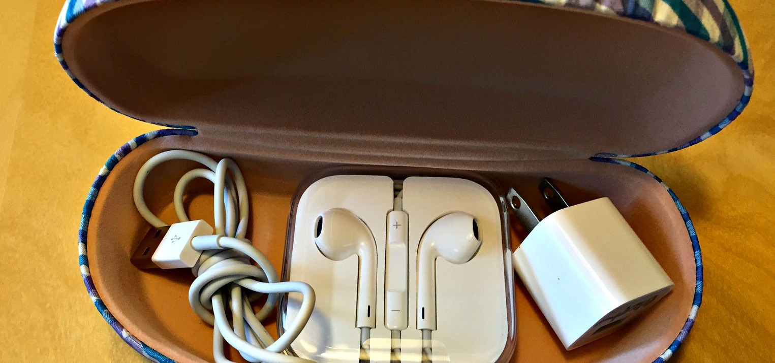 An easy storage hack is storing an iPhone charger, cable, and headphones in a sunglasses case or eyeglasses case.