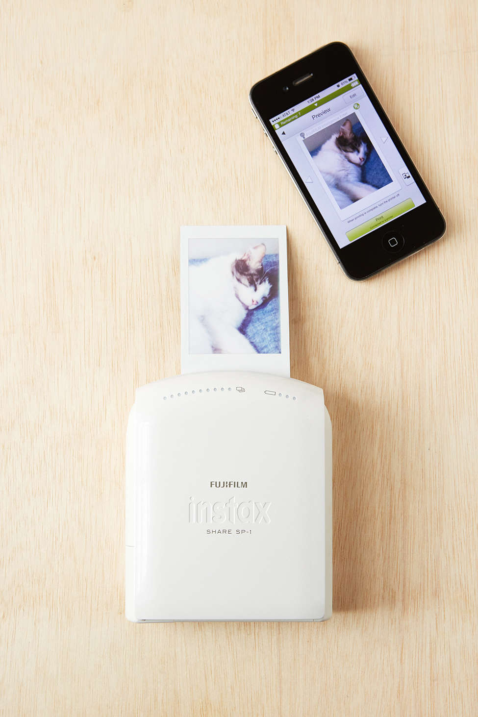 A Fujifilm Instax Instant Smartphone Printer printing cat images is one of various creative Valentine's Day gifts for her or him.