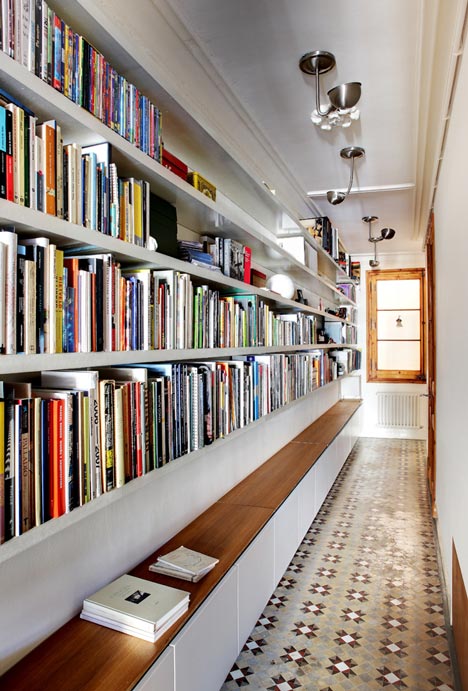 Book storage hack: DIY bookshelves into walls to build a hallway library in a small apartment.