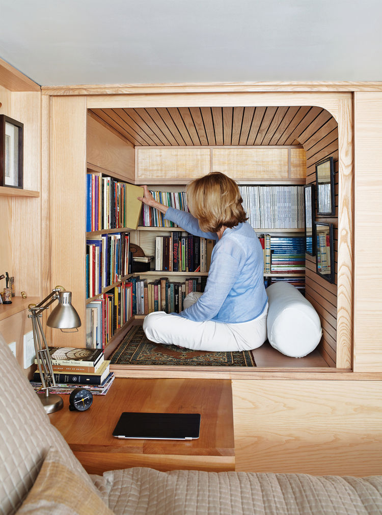 Building a wooden book cabinet under a loft bed is one of many smart book storage hacks.