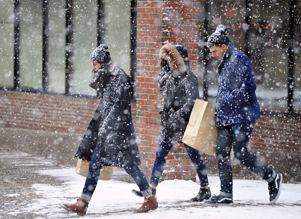 Two female and one male are shopping in Old Port, Maine, an easy way to cure cabin fever.