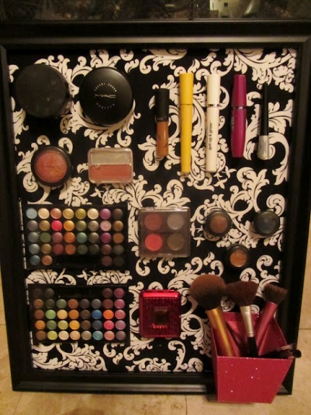 A DIY makeup board is organizing and storing eyeshadow, blush, lip liner, eyeliner, and various makeup brushes.