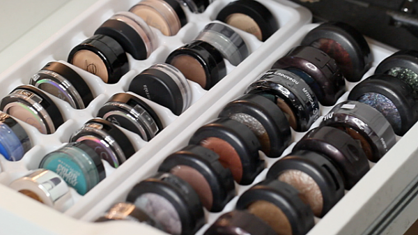 White ice cube trays used as an eyeshadow storage and organization solution.