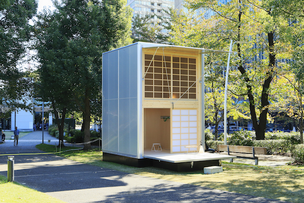 The exterior of a MUJI Aluminum Hut, a minimal Japanese prefab house.