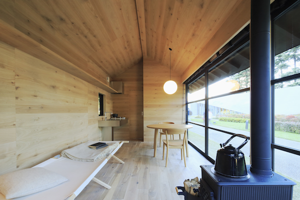 The minimal interior of a MUJI Wooden Hut, a prefab home in Japan.
