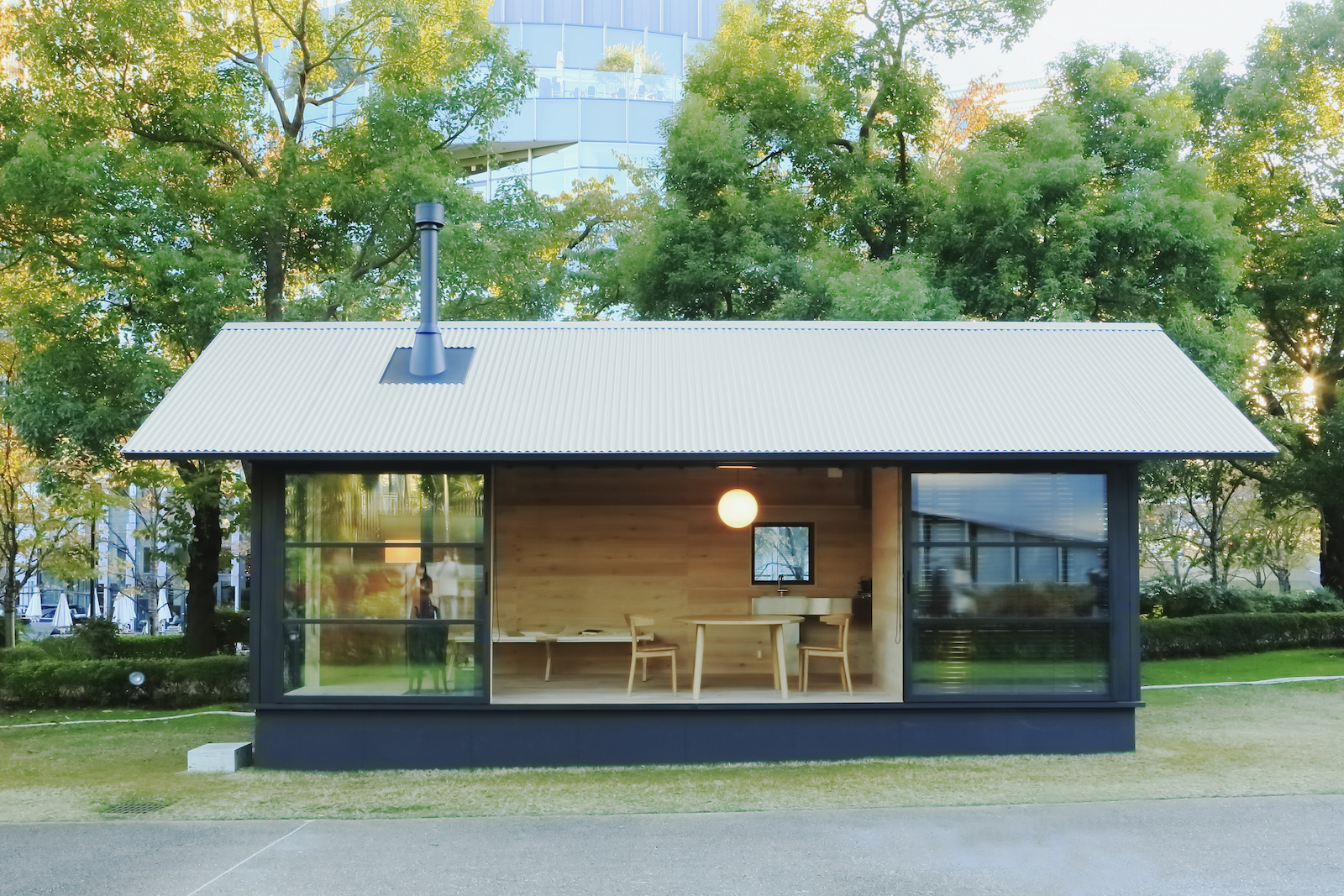 The exterior of a MUJI Wooden Hut, a prefab home built in Japan.