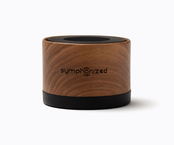 A small bamboo NXT Walnut Bluetooth Portable Speaker with a strong rubber bottom for stability