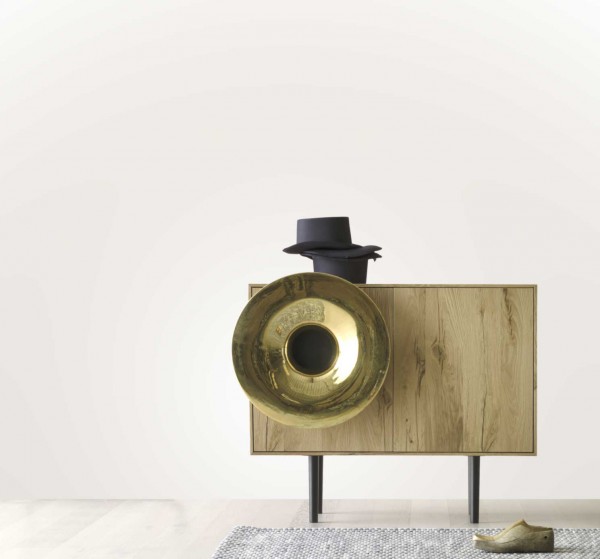 An oak veneered Caruso audio system with a pure gold plated horn is also a credenza with storage shelves.