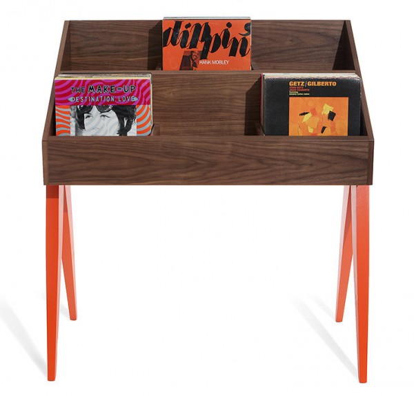 An Atocha Design Record Stand that has a walnut base with solid American maple legs painted orangey-red.