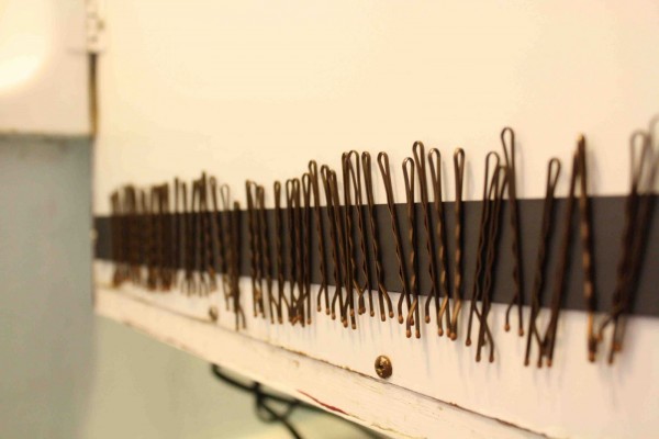 declutter bobby pins by storing them on a magnetic strip on the inside of a medicine cabinet's door