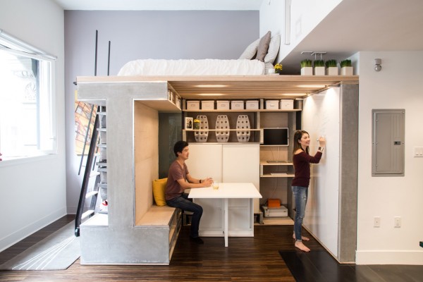 nicki wang writing on the domino loft system's whiteboard while donnie wang watches