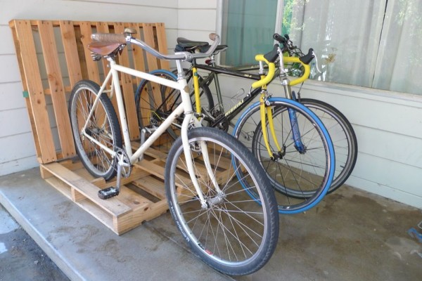 Lean two wooden shipping pallets against each other and voila, you have a new cheap bike rack.