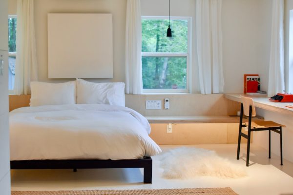 spacious room with a work desk and a window