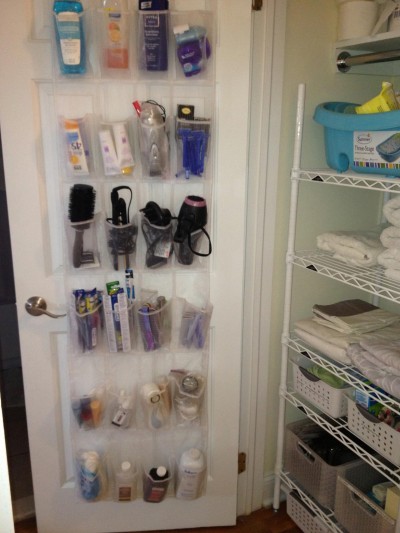 An over-the-door shoe organizer used for bathroom storage by Cut The Clutter.