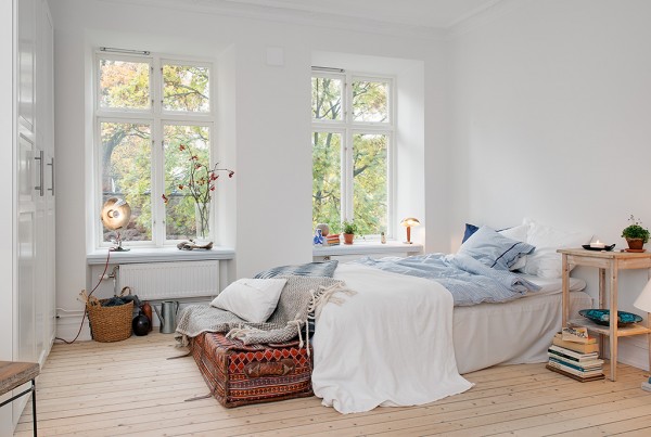 A cozy bedroom in a 387 sq ft apartment in Sweden.