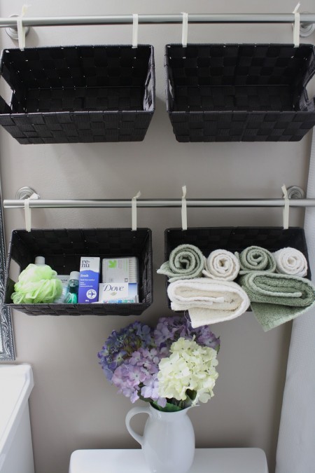 wall of a black baskets used for toiletry and towel storage