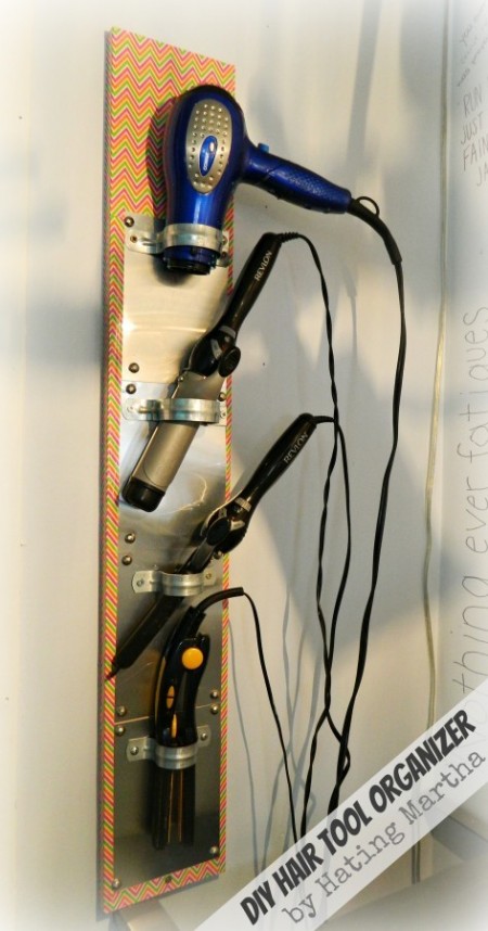 diy hair tool organizer storing a hair dryer, curling iron, curling wand, and hair straightener