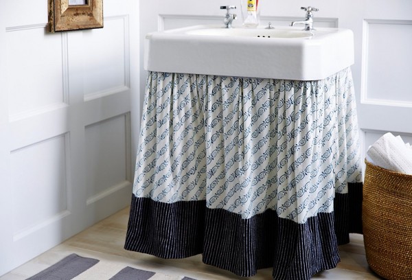 skirted pedestal sink used for hidden storage in a bathroom