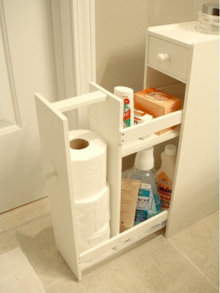 a slim white proman free-standing cabinet is next to a wall and storing various bathroom supplies