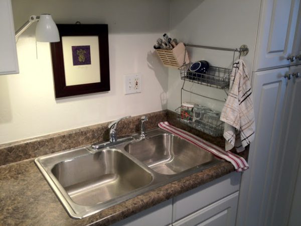 cheap kitchen storage hack: use an ikea bygel rail, bygel wire baskets, and a cutlery caddy to store and dry dishes