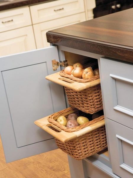genius kitchen cabinet storage hack: pull-out wicker baskets for storing onions and potatoes