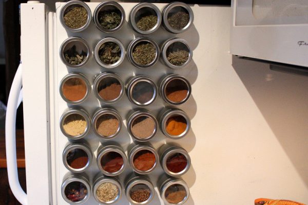 kitchen storage solutions ikea: magnetic tins as spice rack on the side of a fridge