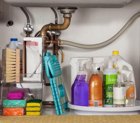 place a lazy susan in a kitchen sink cabinet to store cleaning products