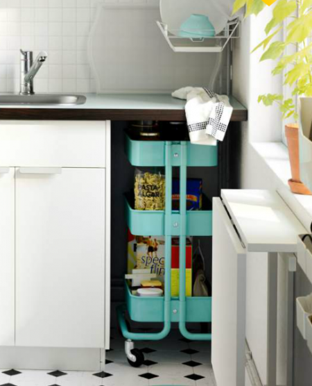 using an ikea raskog utility cart to store kitchen supplies or jars and boxes of food is a smart and affordable kitchen storage solution