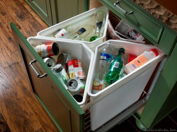 a 4-compartment recycling center that pulls out from a kitchen cabinet is a brilliant diy idea