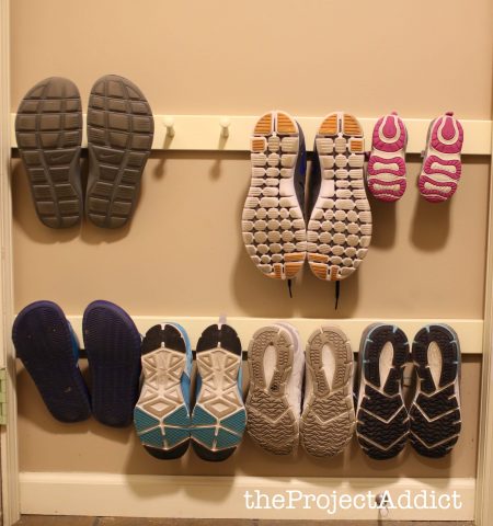 diy shoe storage hack made from wall-mounted boards with pegs