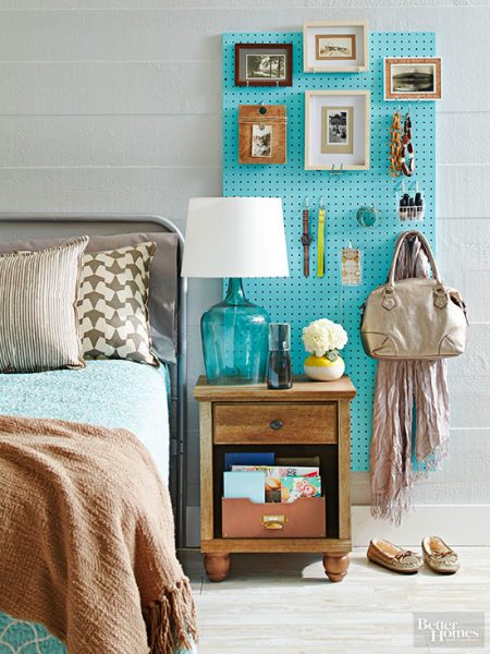 diy pegboard organizer storing picture frames, watches, bracelets, a handbag, a scarf, and more