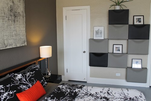 a wall of gray and black ikea trones is a stylish and cheap bedroom storage solution