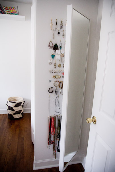 wall-mounted diy mirror jewelry cabinet in a bedroom