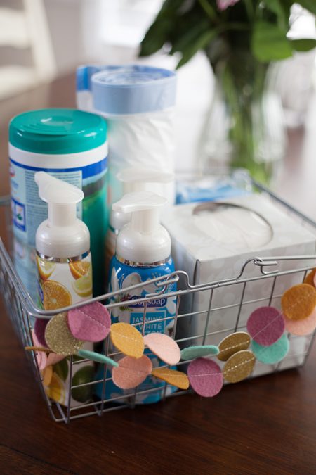 diy moving survival kit with clorox wipes, softsoap, hand lotion, a tissue box, and trash bags