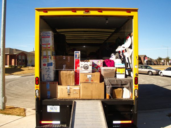 how to load a moving truck: load heavy items like a sofa first, followed by light items like boxes and chairs