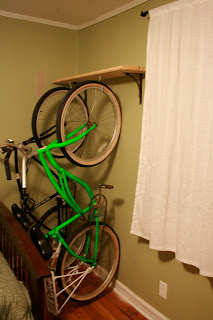 A DIY beach cruiser rack made from hooks installed into a floating shelf