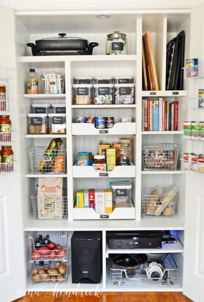 organized pantry closet with baskets, shelves, drawers, dividers, and jars
