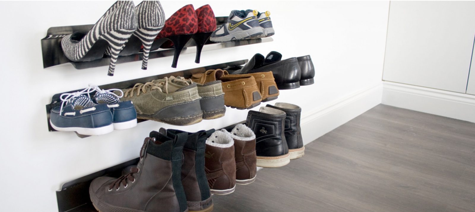 shoes, boots, sneakers, and heels stored on wall-mounted shoe racks