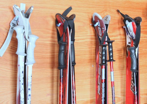 4 pairs of skis and ski poles strapped together