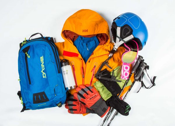 skiing equipment consisting of ski poles, googles, jacket, backpack, helmet, gloves, socks, canteen, and tools