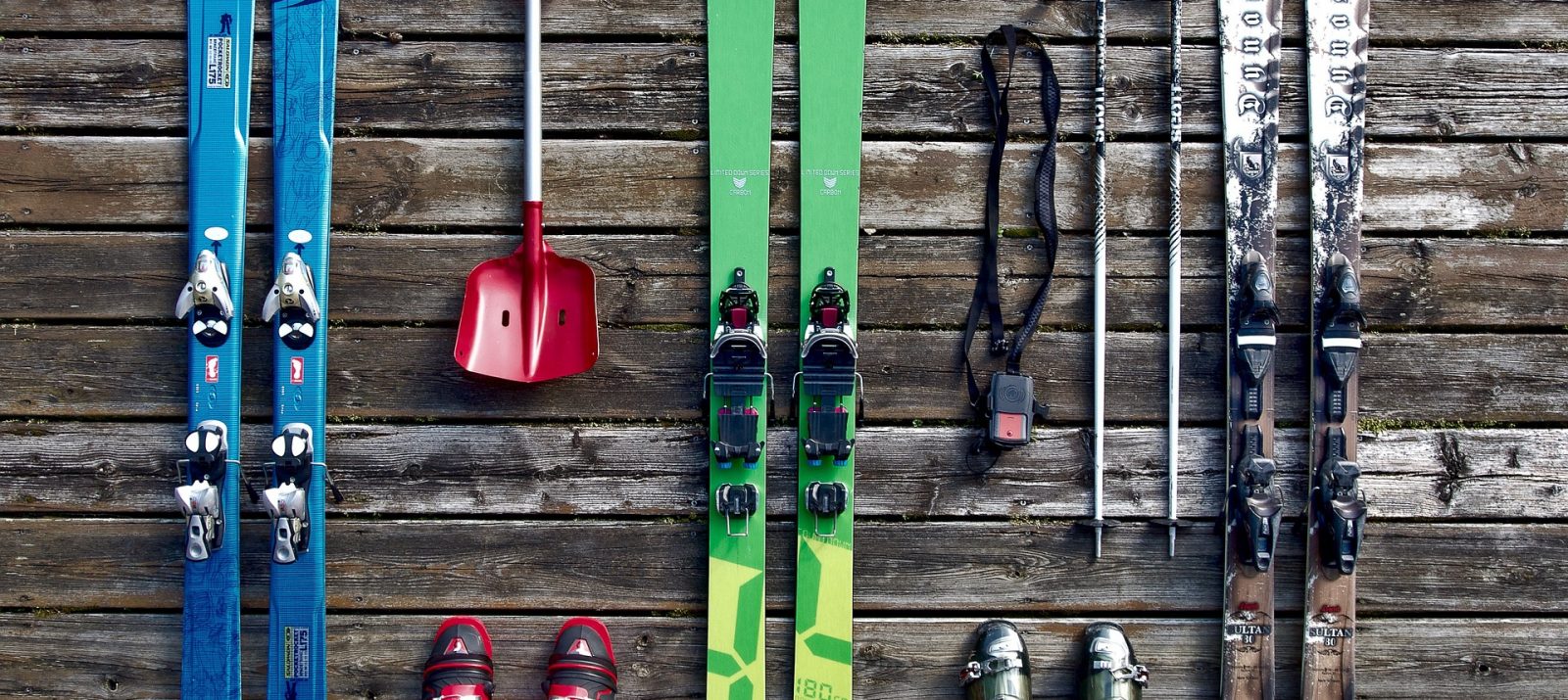 skis, ski boots, ski poles, and a shovel