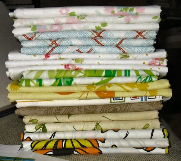 stack of folded bed sheets