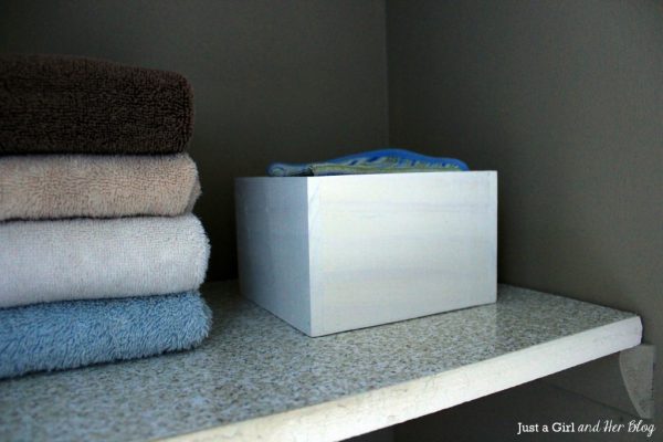 organize linen closet shelves with diy storage boxes made from wood