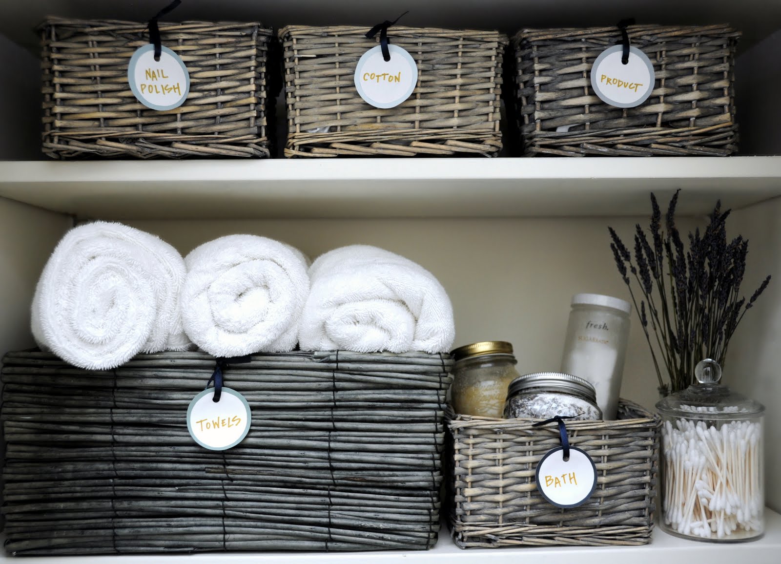 how to organize linen closet: declutter, sort by category, and store things in storage baskets with labels