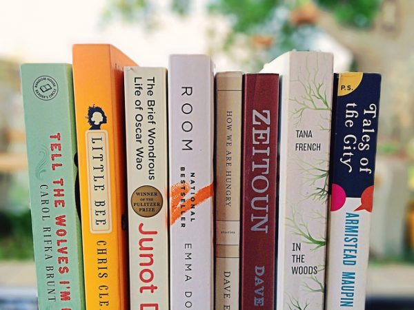 8 books on a bookshelf at a booksale