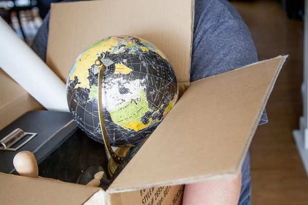 cardboard box for packing and moving globe, wooden figurine, poster, and more