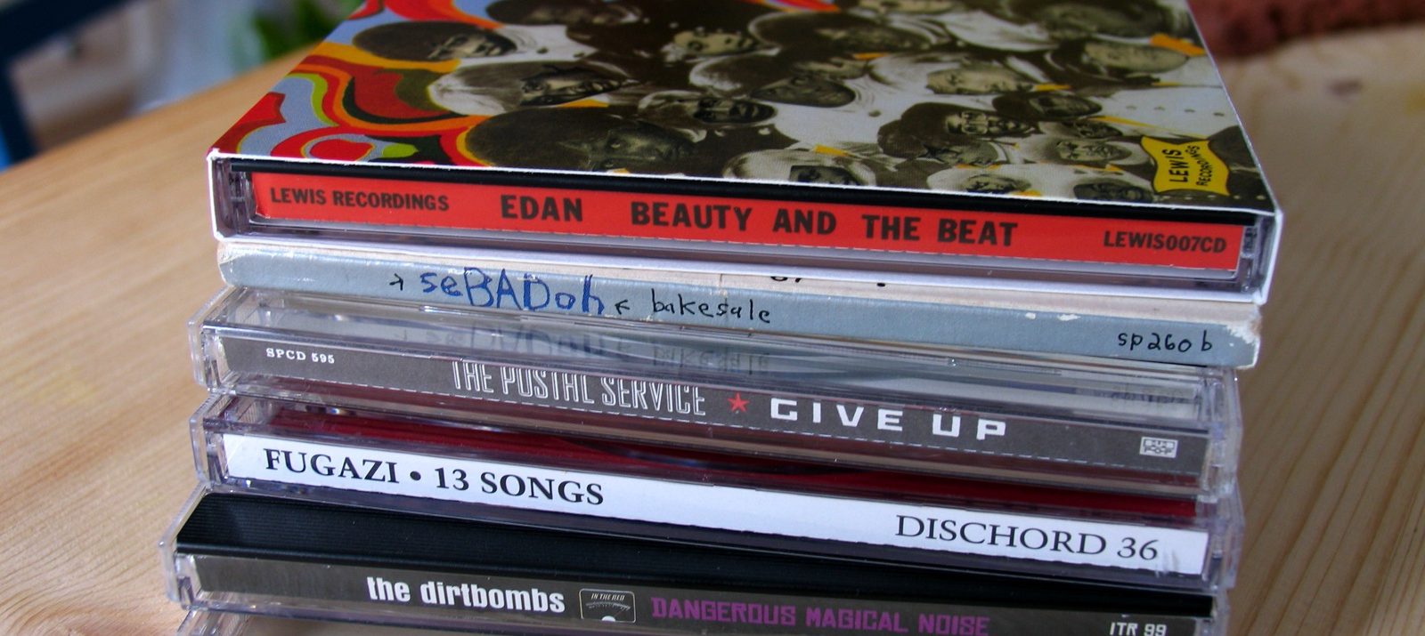 stack of 7 cd cases on a wooden table