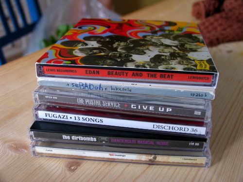 stack of 7 cd cases on a wooden table