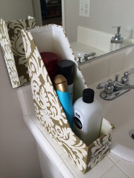 fleur-de-lis file holder as a shampoo and hairspray bottle holder in a bathroom