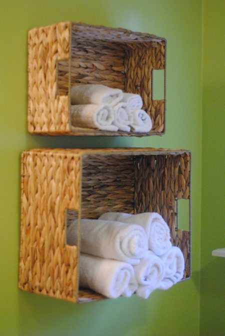 diy bathroom towel storage baskets mounted on a wall